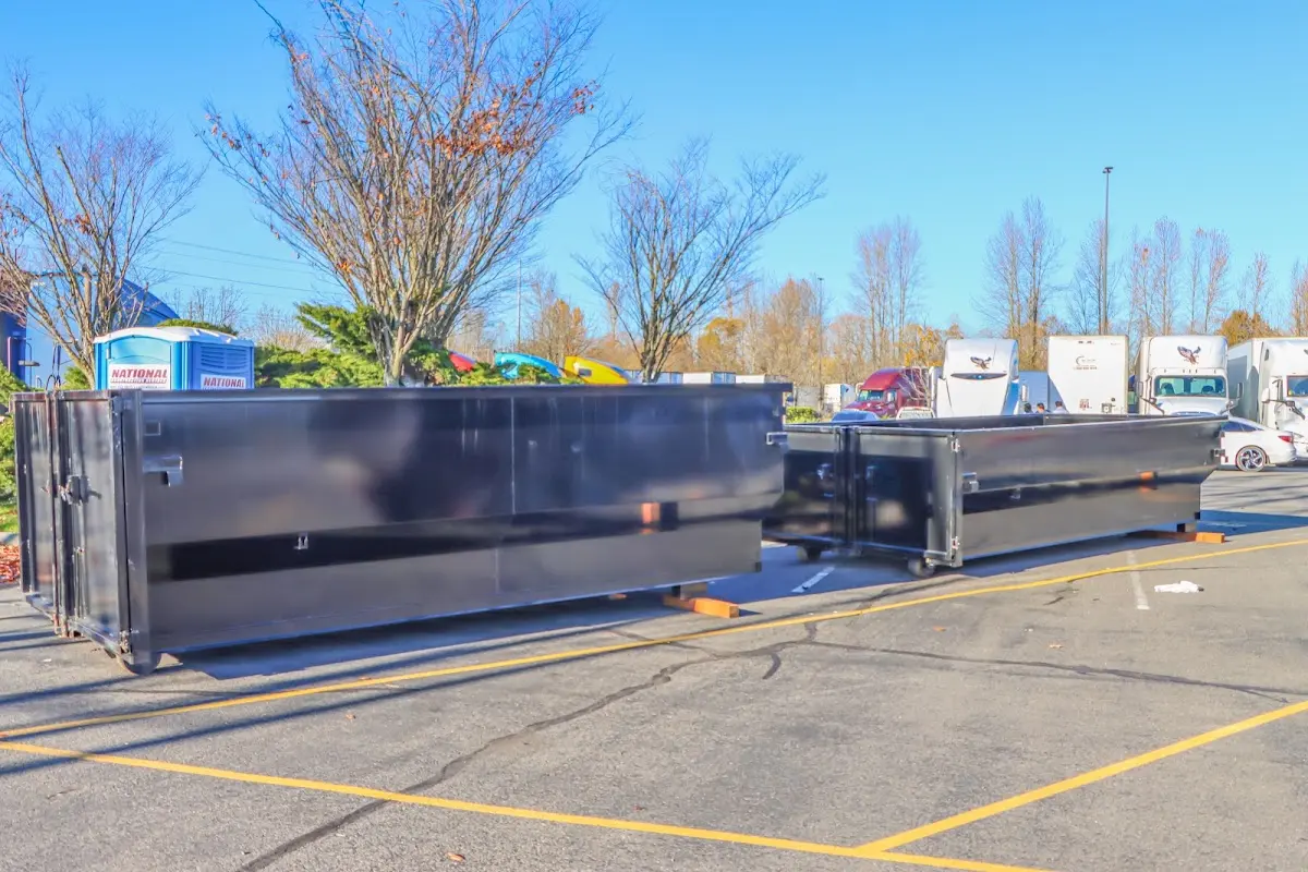 Professional dumpster rental service with roll-off container on residential driveway in Minnetrista
